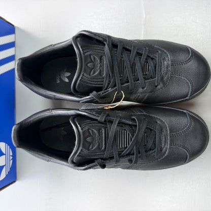 Adidas black Gazelle trainers leather upper with iconic three stripes logo.