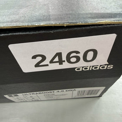 Adidas Ultra Boost 4.0 DNA white trainers with black accents and signature three-stripe logo.