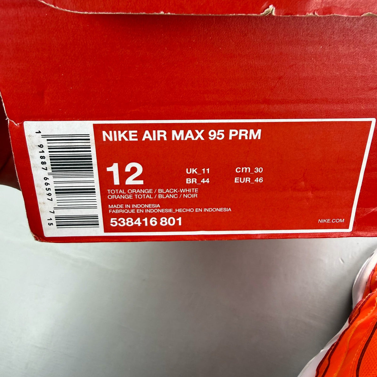 Nike Air Max 95 orange trainers with white overbranding and logo details.