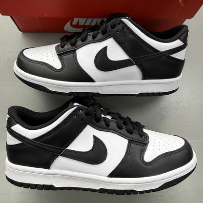 Nike Dunk Low white and black sneakers with retro panda design and logo.