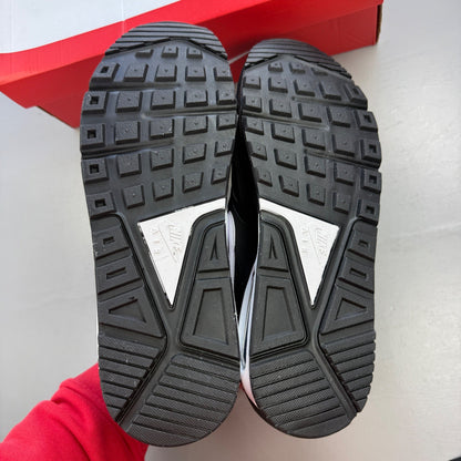 Nike running shoes black and white, featuring classic logo and sleek design.