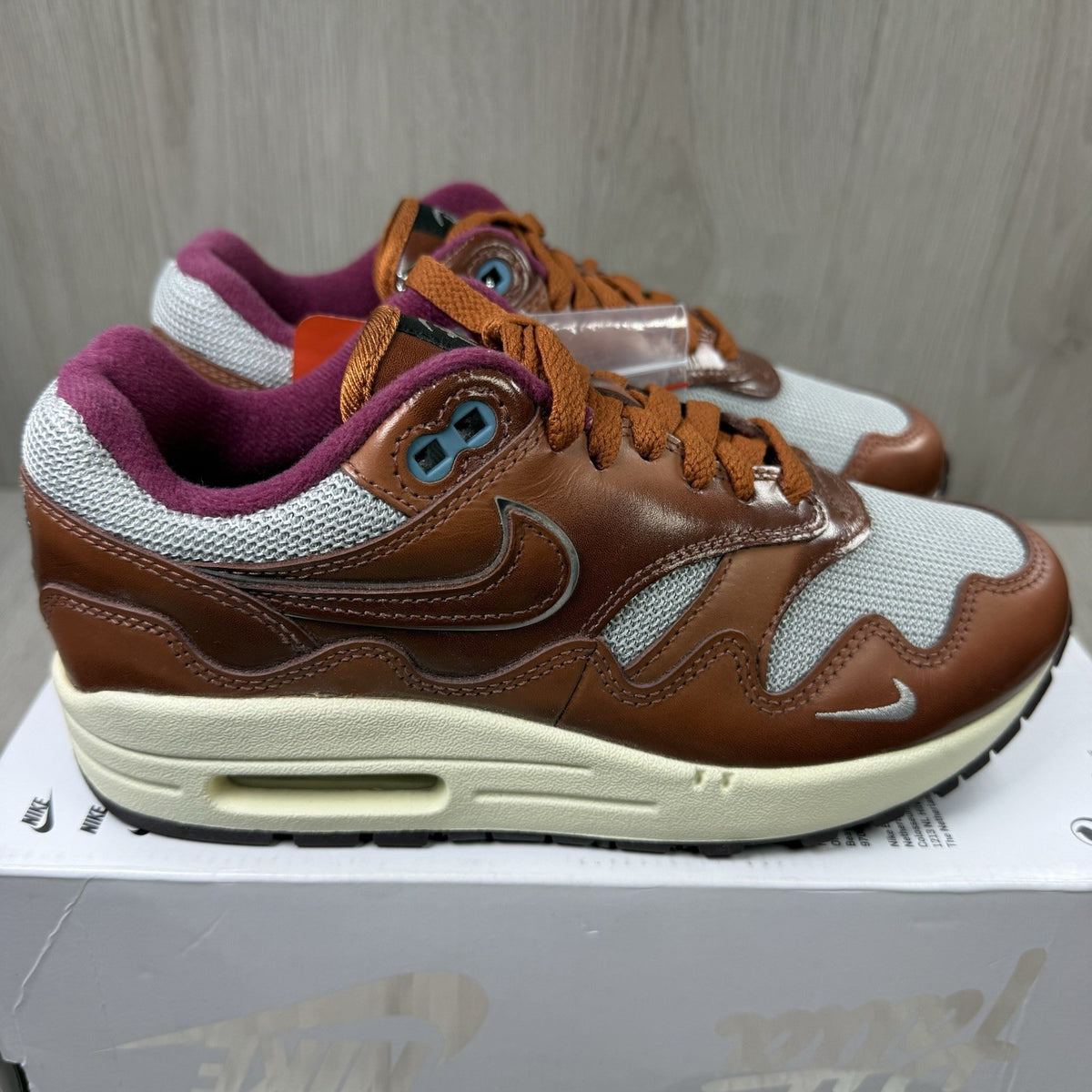 Nike Air Max 1 brown trainers with unique Patta logo and premium suede material.