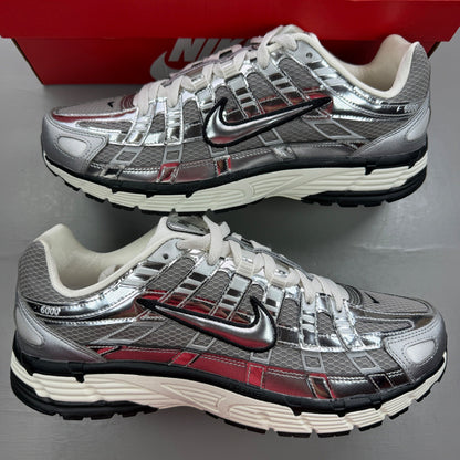 Nike deck shoes metallic silver with black and white accents, featuring logo details.