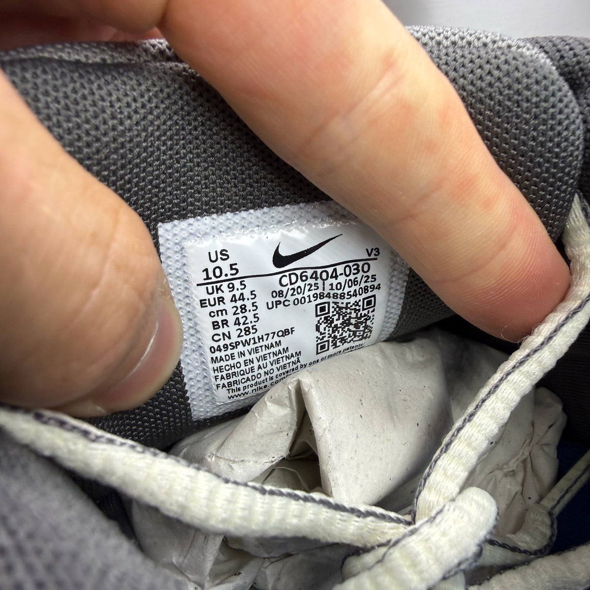 Nike grey blue trainers with pencil point design and logo detail.