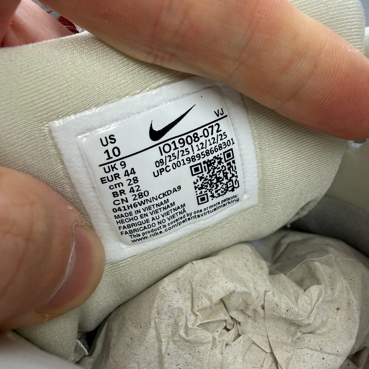 Nike Air Max 90 beige trainers with swoosh logo and mesh detailing.