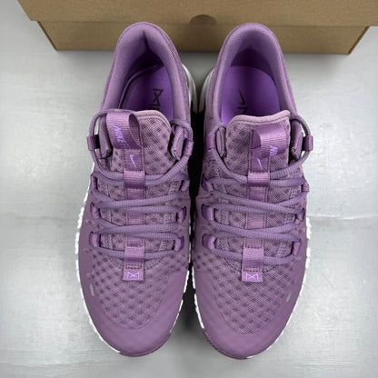 Nike Free Metcon 5 purple trainers with mesh upper and logo detail.