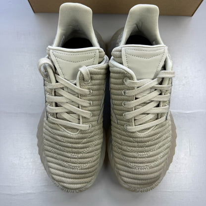 Adidas grey trainers with textured upper and distinctive three-stripe logo detail.