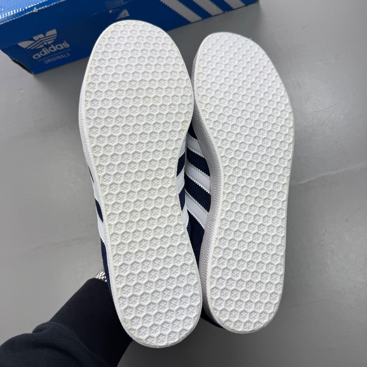 Adidas blue suede trainers with white stripes and logo detail.
