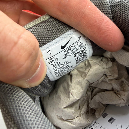 Nike Air Max 90 PRM grey trainers with white accents and distinctive logo details.