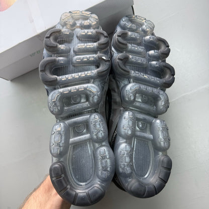 Nike Air VaporMax 2019 black trainers with distinctive air cushioning and sleek design.