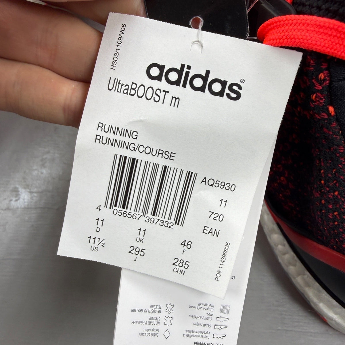 Adidas Ultra Boost 2.0 red trainers with black accents and signature three-stripe logo.