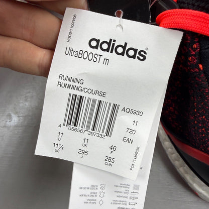 Adidas Ultra Boost 2.0 red trainers with black accents and signature three-stripe logo.