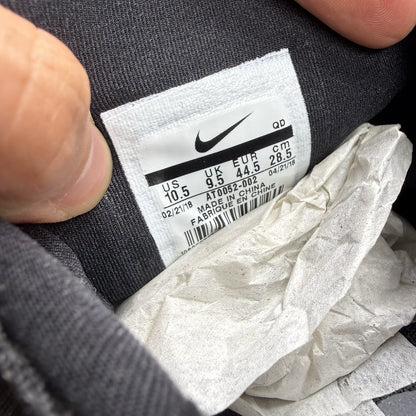 Nike Presto Fly black trainers with dark grey accents and logo detail.