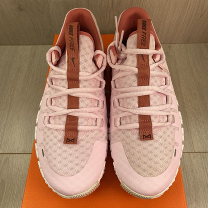 Nike Free Metcon 5 pink foam trainers with white accents and logo detailing.