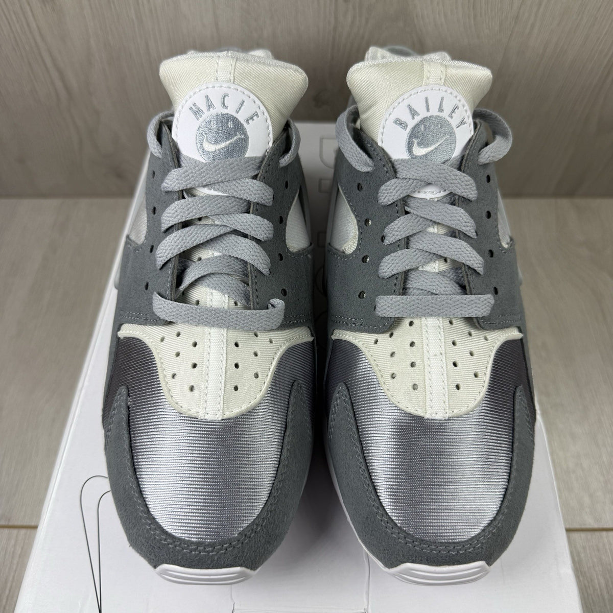 Nike white trainers with grey accents and signature logo on the tongue.