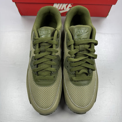 Nike Air Max 90 Essential green trainers with khaki accents and signature swoosh logo.