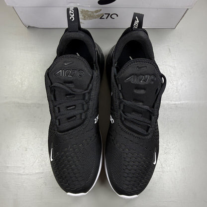 Nike Air Max 270 black trainers with white accents and logo detail.