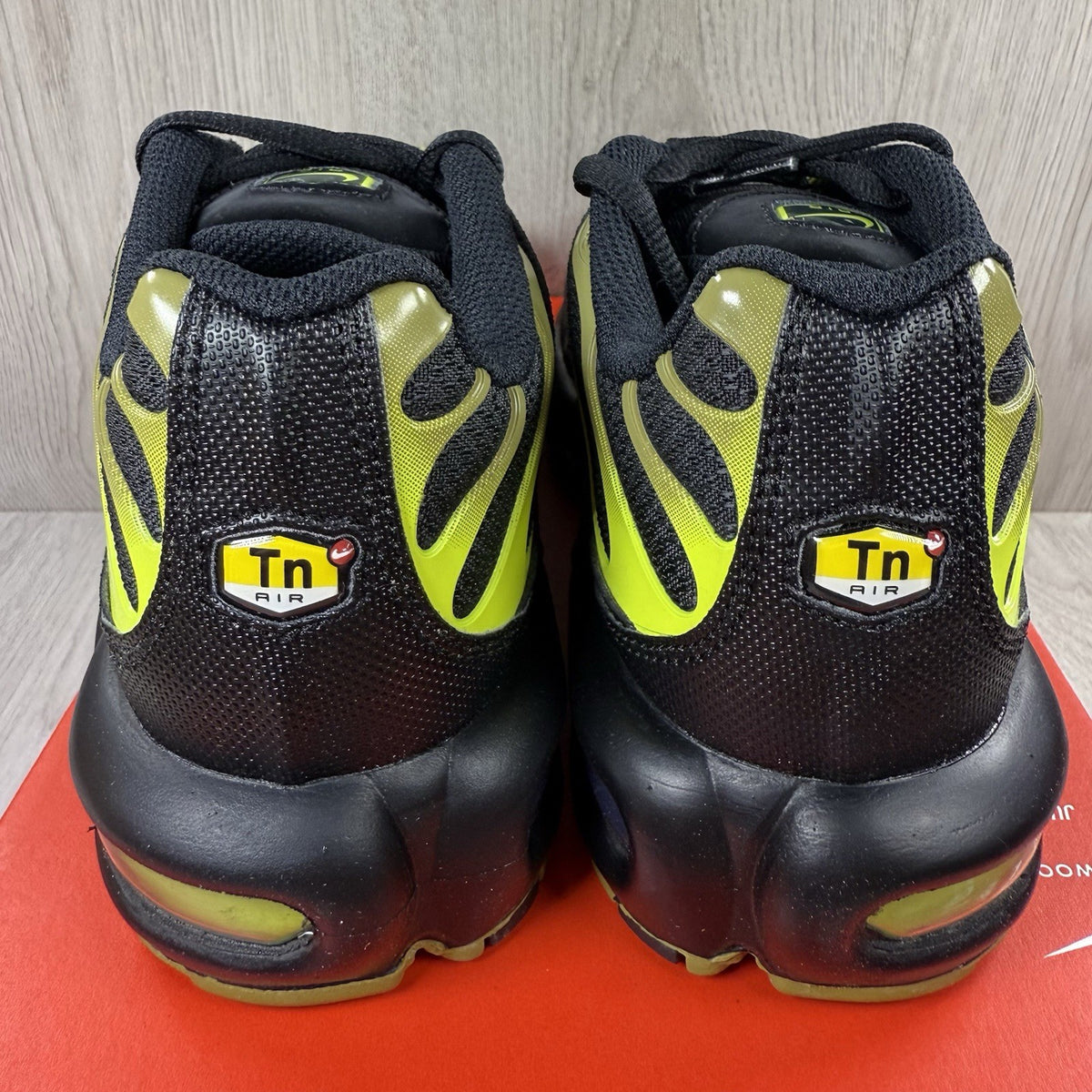 Nike Air Max Plus TN trainers black with moss green accents and signature logo.