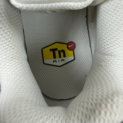 Nike Air Max Plus TN trainers white with black accents and signature logo details.