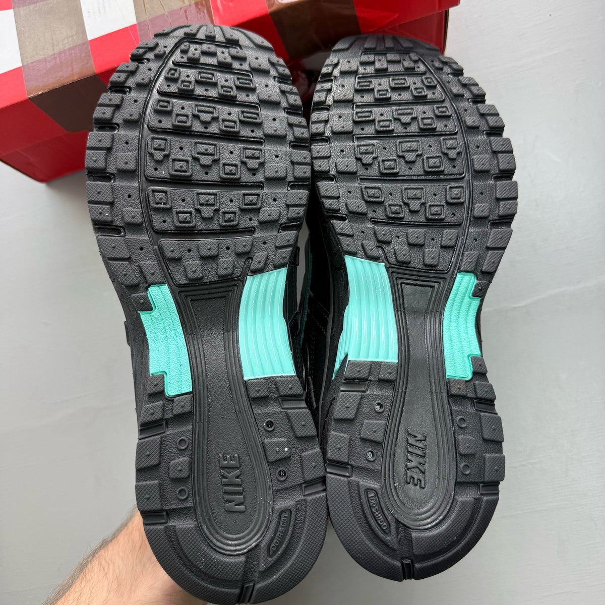 Nike P-6000 black trainers with hyper turquoise accents and grey detailing.