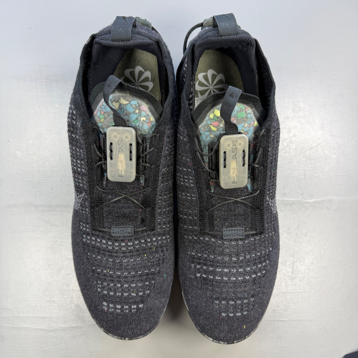 Nike black trainers Flyknit upper with grey accents and Air Max cushioning.