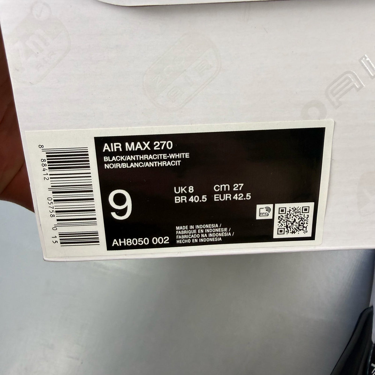 Nike black Air Max 270 trainers with white accents and logo detail.
