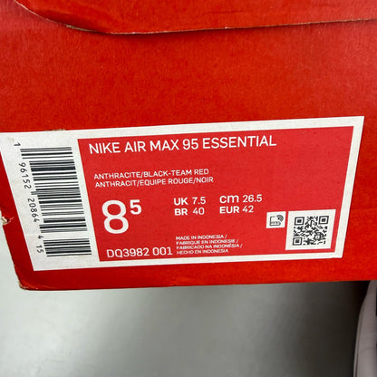 Nike black trainers with red accents and grey detailing, featuring iconic Air Max design.