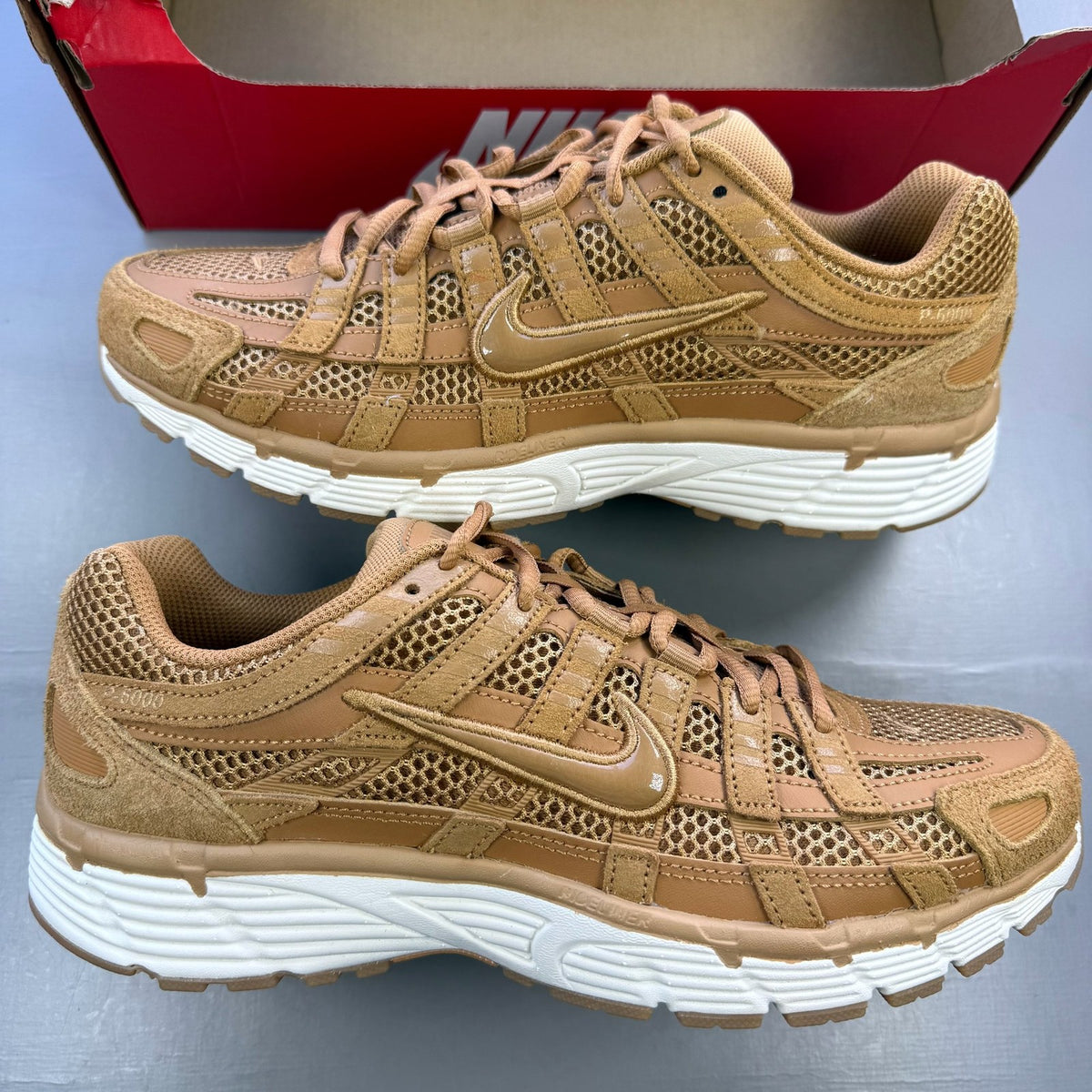 Nike P-6000 SE trainers multi-colour with metallic gold accents and mesh detailing.