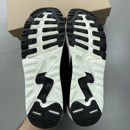 Nike black trainers with dark grey accents and white air bubbles, featuring signature logo.
