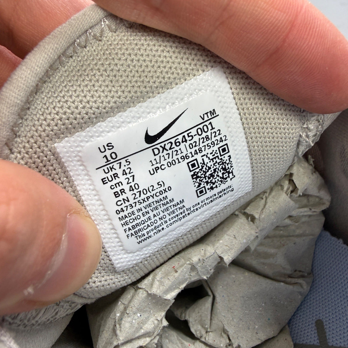 Nike grey trainers with Air Max cushioning and logo detail on the tongue.