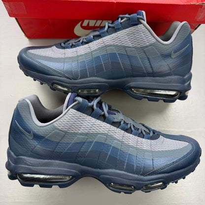 Nike Air Max 95 blue trainers with mesh upper and rubber sole, featuring logo detail.