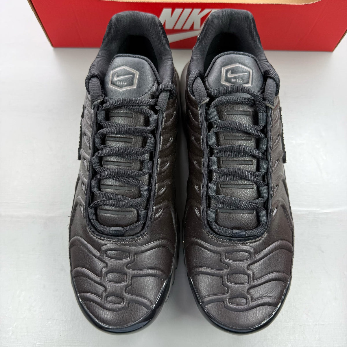 Nike Air Max Plus TN Premium black trainers with signature logo and sleek design.