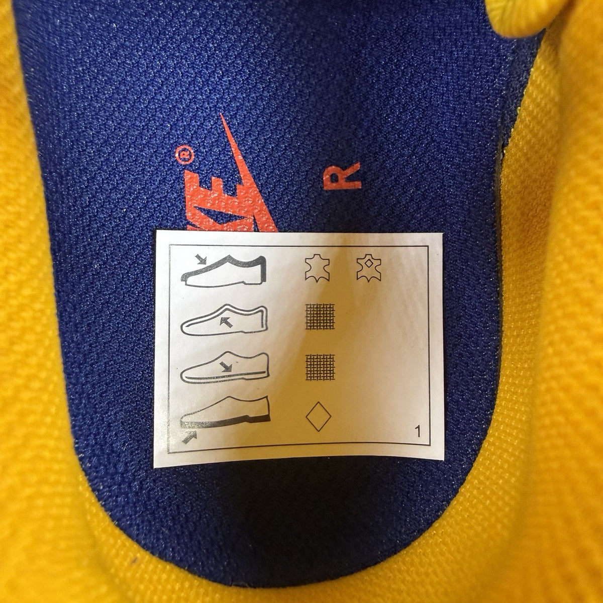 Nike blue trainers with gold accents and retro design elements.
