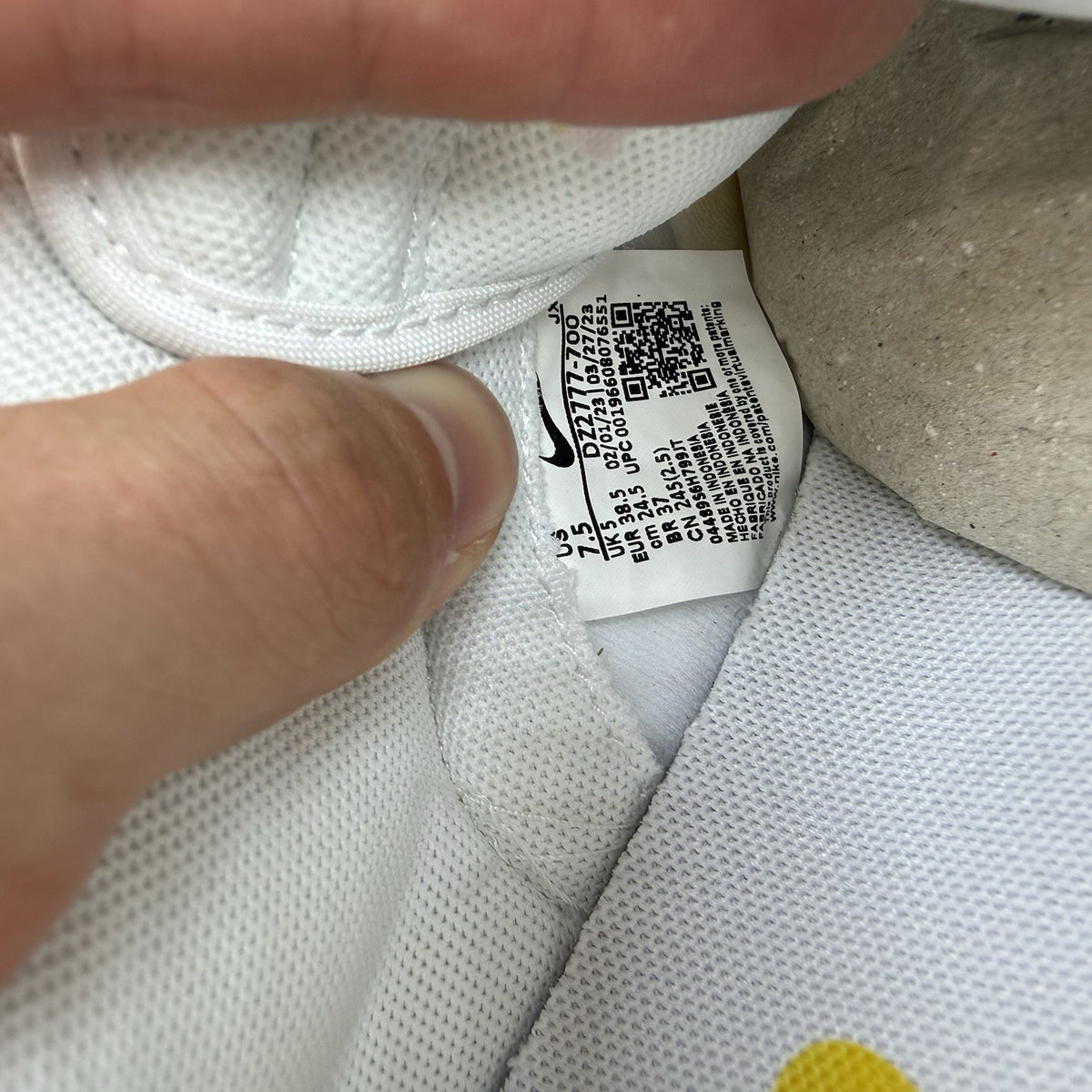 Nike Dunk Low white trainers with yellow gingham pattern and brown gum sole.