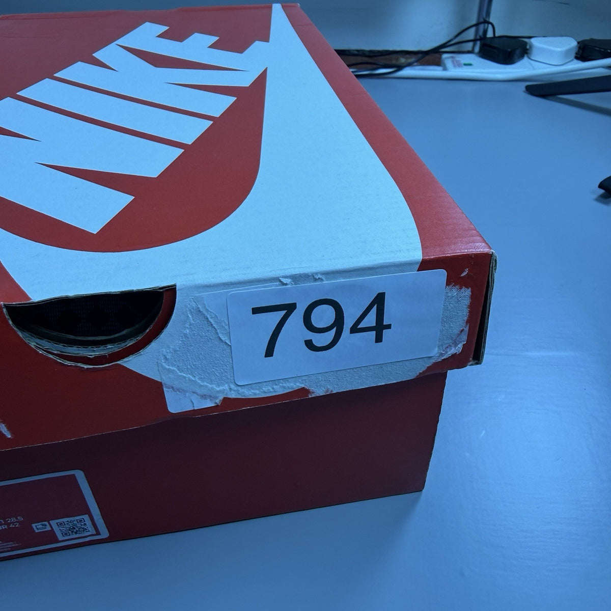 Nike Air Max Plus TN Ultra white trainers with reflective accents and signature swoosh logo.