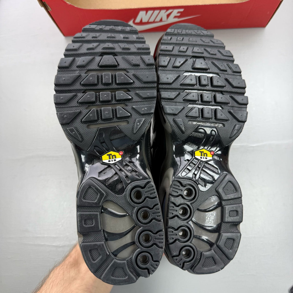 Nike Air Max Plus TN Premium black trainers with signature logo and sleek design.