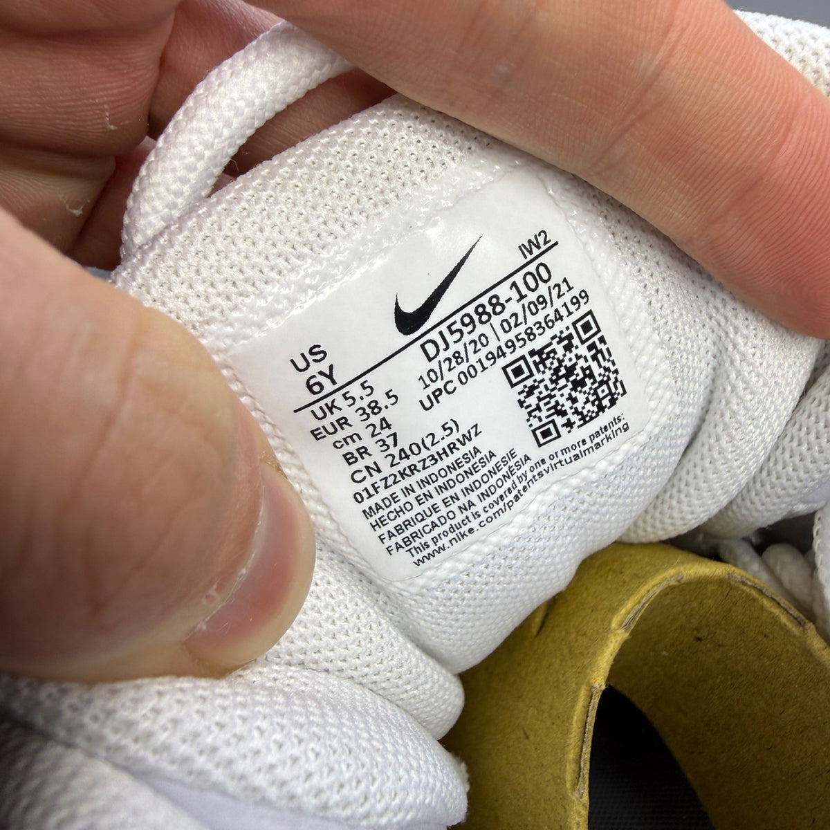 Nike athletic shoes white with varsity red accents and bold "AIR" lettering.