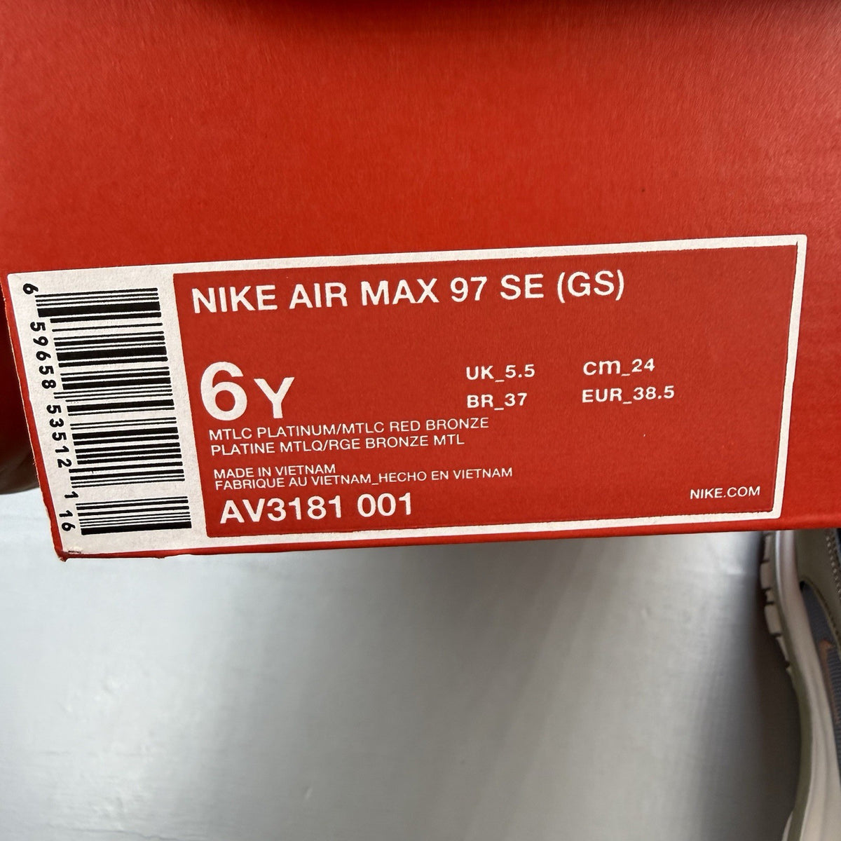 Nike Air Max 97 SE metallic silver trainers with bronze accents and white sole.