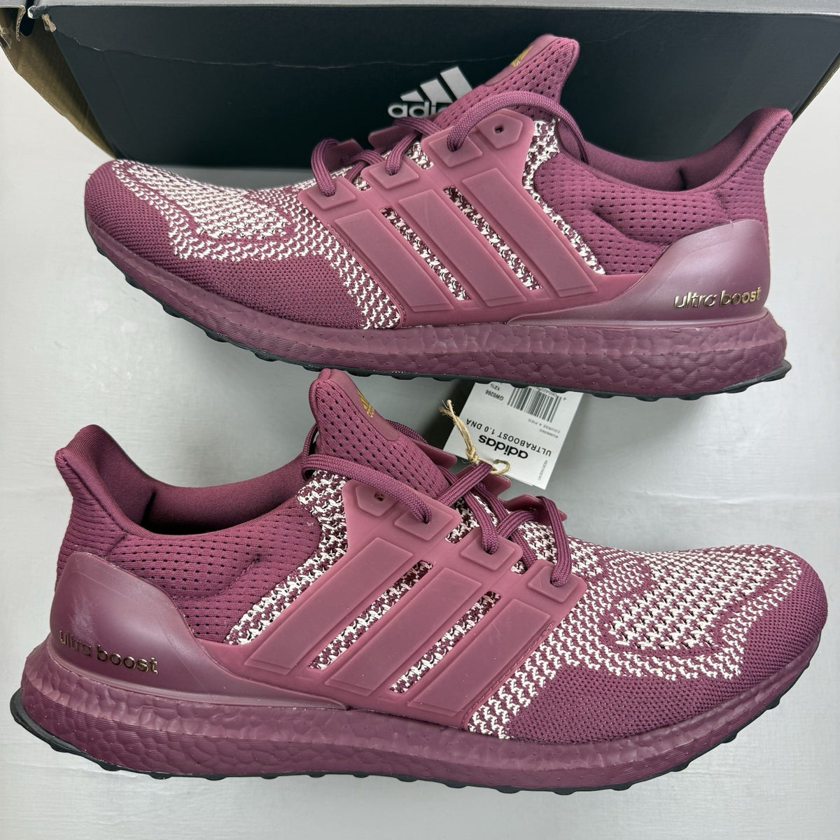 Adidas UltraBoost 1.0 DNA red trainers with signature three stripes and knit upper.