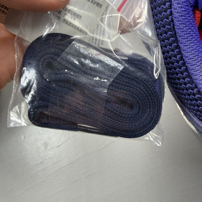 Adidas blue ZX Flux trainers with red and white woven pattern, logo on tongue.