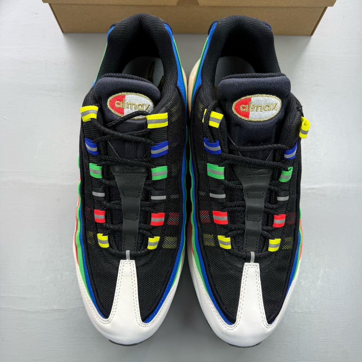 Nike black Air Max 95 trainers with hidden message detail and sleek design.