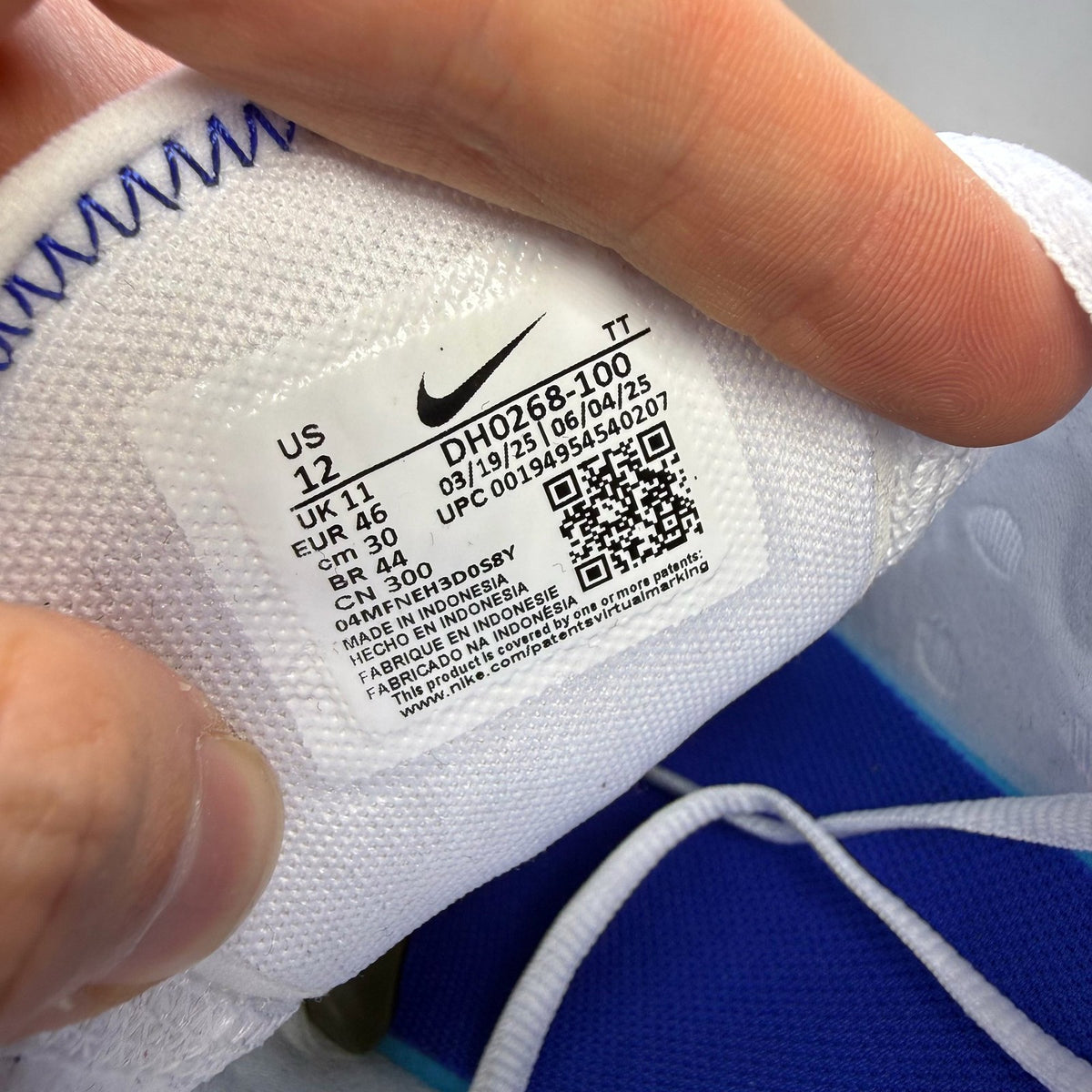 Nike Air Max 270 white trainers with racer blue accents and logo detail.