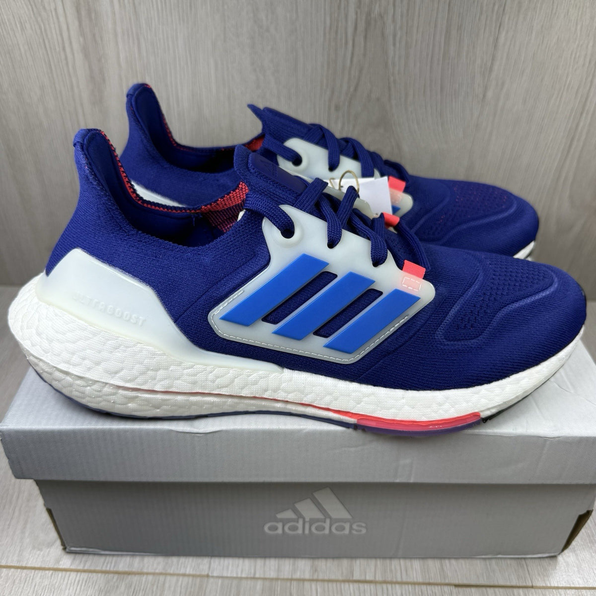 Adidas Ultra Boost 22 trainers in legacy indigo with turbo blue and white accents.