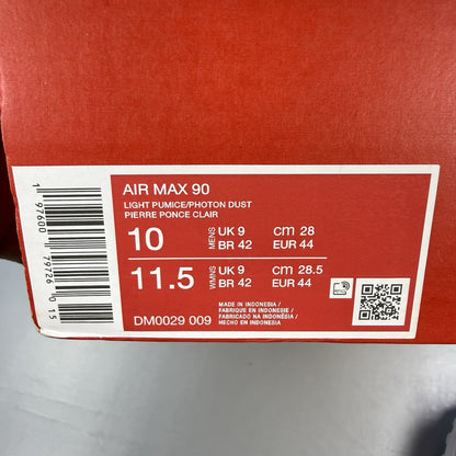 Nike Air Max 90 grey trainers with blue and white accents, featuring iconic logo.
