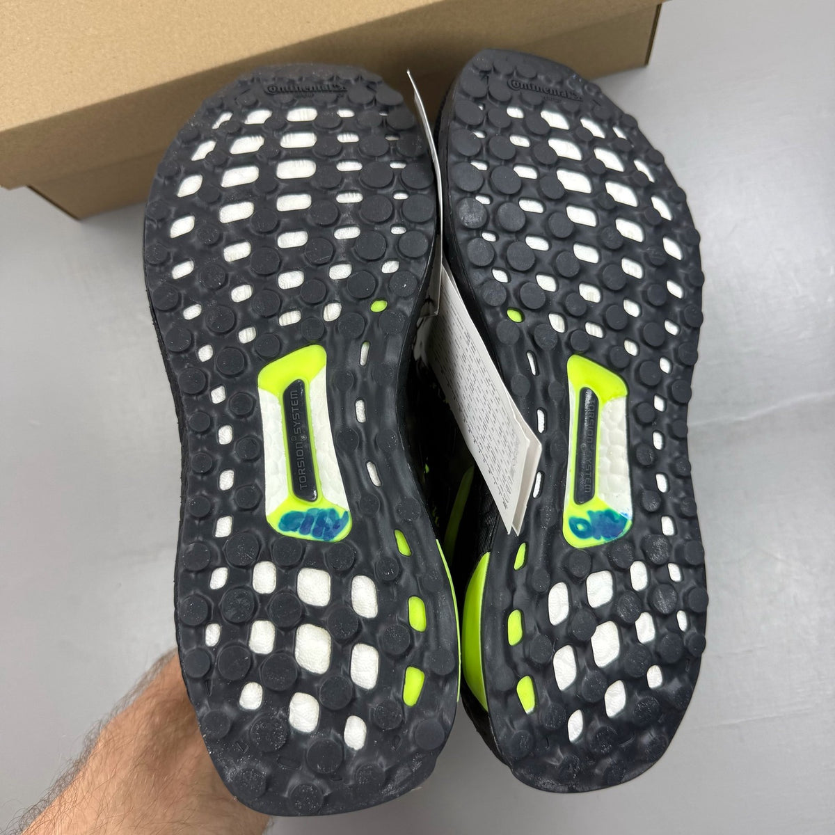 Adidas black Ultraboost 1.0 trainers with Lucid Lemon accents and breathable mesh upper.
