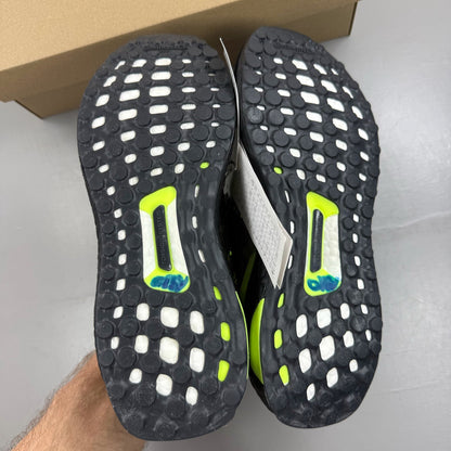Adidas black Ultraboost 1.0 trainers with Lucid Lemon accents and breathable mesh upper.