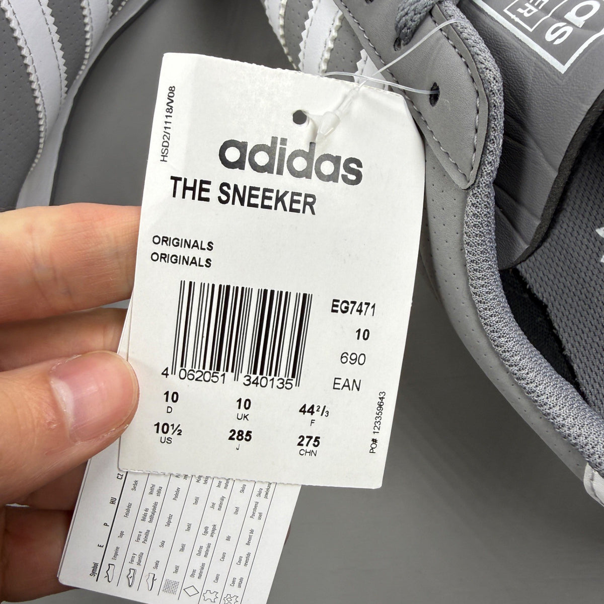 Adidas grey deck shoes with white accents and classic logo detailing.