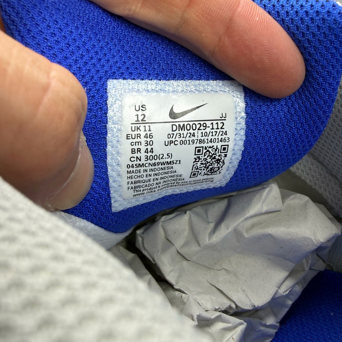 Nike Air Max 90 trainers white grey blue with signature swoosh logo and mesh details.