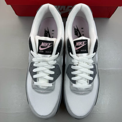 Nike Air Max 90 grey trainers with pink foam accents and white sole.
