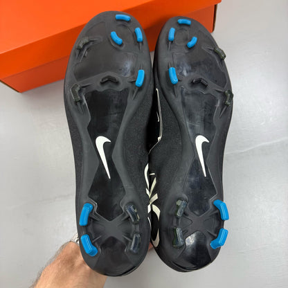 Nike black football boots with white Mercurial logo, sleek design, synthetic material.